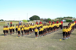Little girl smiling at the camera on a football match